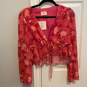 Floral pink print tie up loose fitting blouse. Never worn with tags.